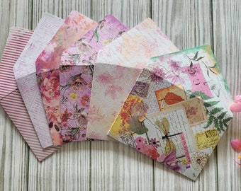 May include: A set of six decorative envelopes with floral and vintage patterns in shades of pink, yellow, and green. The envelopes are made of paper and have a textured finish.