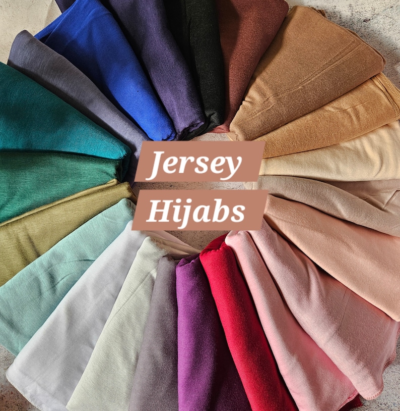 K&ouml;nnte beinhalten: Eine Auswahl an Jersey-Hijab-Stoffen in einer Regenbogenpalette von Farben, darunter Teal, Gr&uuml;n, Beige, Hellblau, Grau, Lila, Rot, Rosa und Braun. Die Stoffe sind in einem Kreis angeordnet, in dessen Mitte der Text "Jersey Hijabs" steht.