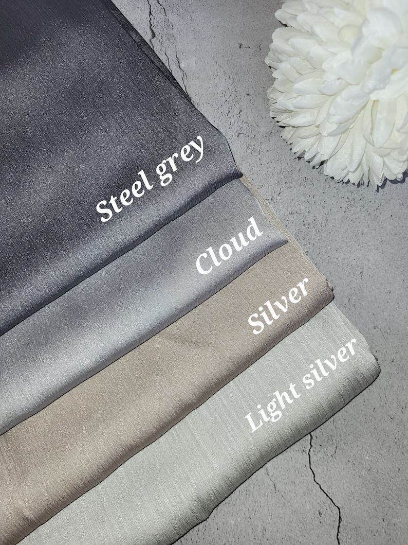 May include: Four fabric swatches in different shades of gray, from dark to light. The swatches are labeled "Steel grey", "Cloud", "Silver", and "Light silver".