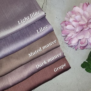 May include: Five swatches of fabric in different shades of purple and brown. The swatches are labeled "Light Lilac", "Lilac", "Muted Mauve", "Dark Mauve", and "Grape".