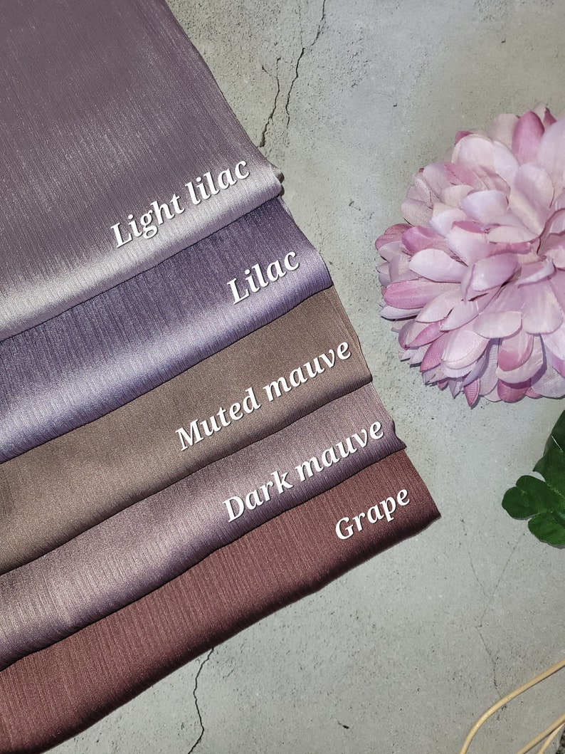 May include: Five swatches of fabric in different shades of purple and brown. The swatches are labeled "Light Lilac", "Lilac", "Muted Mauve", "Dark Mauve", and "Grape".