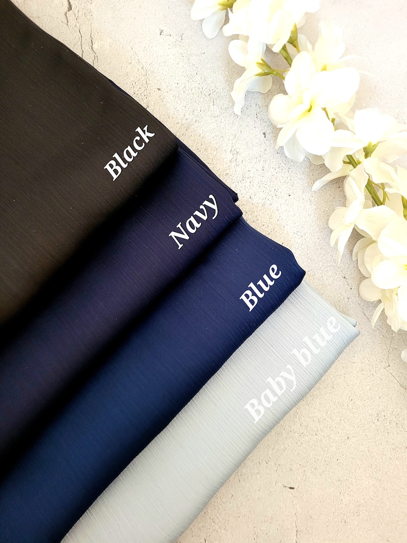 May include: Four fabric swatches in different shades of blue, from dark to light. The swatches are labeled "Black", "Navy", "Blue", and "Baby Blue".