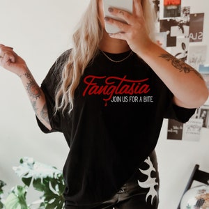 May include: Black t-shirt with red text that reads "Fangtasia Join Us For A Bite".