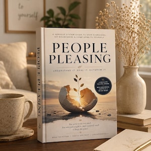 May include: A hardcover book titled "People Pleasing" with the subtitle "Understand It. Heal It. Outgrow It." The cover features an image of a cracked egg with a plant growing out of it. The book is on a wooden table.