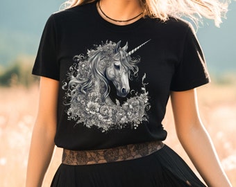 May include: Black t-shirt with a graphic print of a white unicorn head surrounded by flowers.