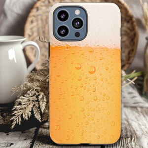 May include: A phone case with a design of a glass of beer with condensation droplets. The case is black and has a clear plastic window to show the phone screen.