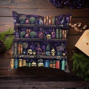 May include: A decorative pillow featuring a detailed illustration of a shelf filled with potion bottles, skulls, books, and plants. The color palette includes shades of purple, green, and brown, creating a gothic or witchy aesthetic. The pillow is designed to resemble a bookshelf.