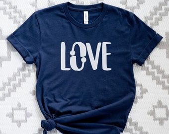 May include: A navy blue t-shirt with a white graphic that says "LOVE" in a stylized font.