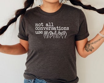 May include: A dark gray t-shirt with the text "not all conversations use" and a row of hand signs in white.
