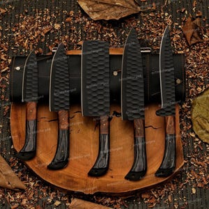 May include: Set of six black kitchen knives with wooden handles, arranged on a wooden cutting board. The knives are all different sizes and shapes, and they are all very sharp.