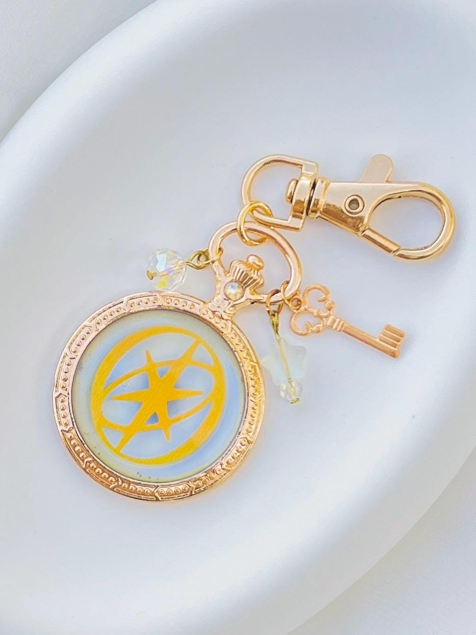Katseye Logo Iridescent Blue, Gold-tone Alloy, Handmade UV Resin