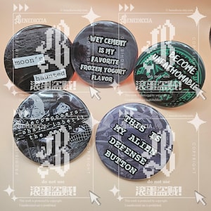 May include: Five circular pin-back buttons featuring various graphic designs and text. The buttons display phrases including moon's haunted, wet cement is my favorite frozen yogurt flavor, become unfathomable, decomposers shall inherit the earth, and this is my alien defense button.