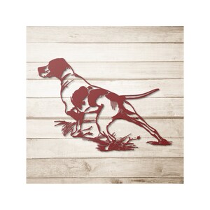 May include: A red metal silhouette of a hunting dog in a running pose against a woodgrain background.