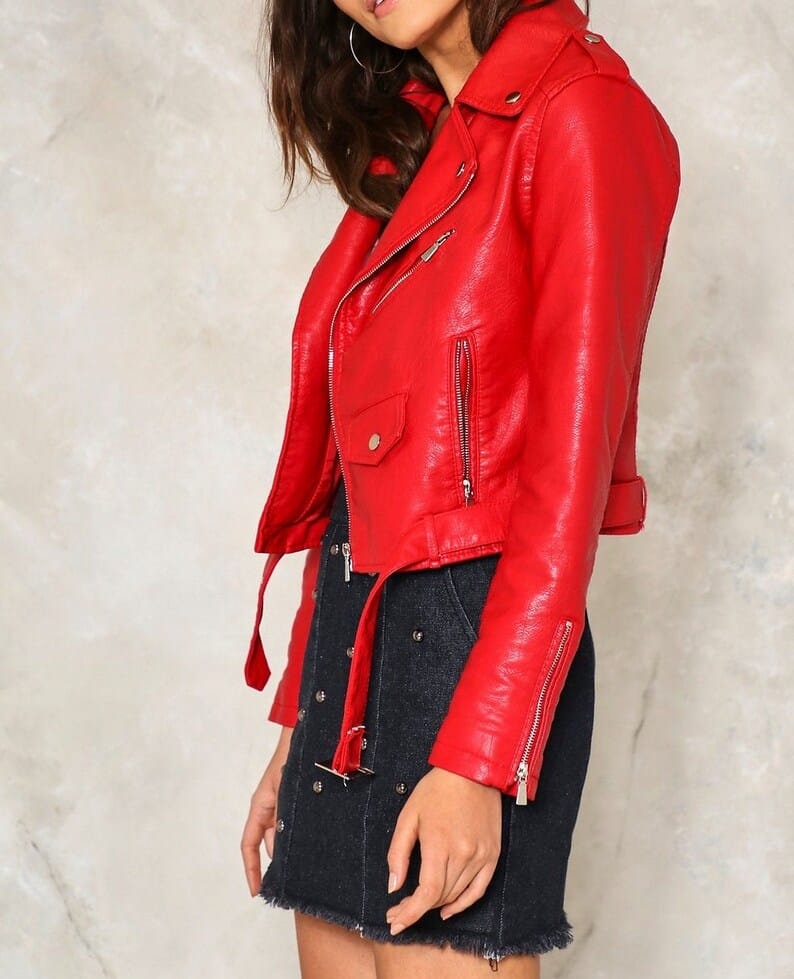 May include: A red faux leather moto jacket with a zipper closure and a belt at the waist.