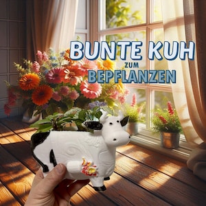 Puede incluir: Un macetero de cerámica blanca en forma de vaca con manchas negras y un diseño floral. El macetero está siendo sostenido en una mano. El texto "BUNTE KUH ZUM BEPFLANZEN" es visible en el fondo.