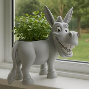 May include: A gray donkey-shaped planter filled with green plants sits on a windowsill. The donkey has a large, smiling mouth and big ears. The background shows a green lawn and two children playing.