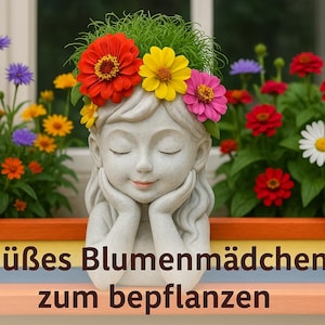 May include: A white ceramic planter shaped like a girl with her head resting on her hands. The planter is decorated with a flower crown made of pink, yellow, and red flowers. The text "Süβes Blumenmädchen zum bepflanzen" is written below the planter.