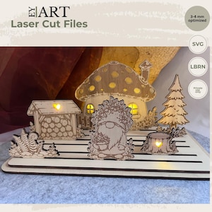 Könnte beinhalten: Ein lasergeschnittenes Holz-Display-Set mit einem pilzförmigen Haus, einem Zwerg, einem Holzschuppen, einem Baum und einem Baumstumpf auf einer geschlitzten Basis. Das Haus und der Stumpf haben herzförmige Ausschnitte mit gelber Beleuchtung.