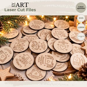 May include: A collection of circular wooden tokens featuring laser-engraved German text and illustrations, including hearts, stars, and various icons. The tokens are optimised for 3-4mm material thickness and are intended for laser cutting projects.