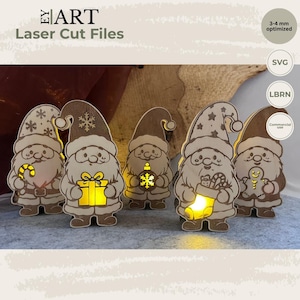 Puede incluir: Cinco figuras de gnomos de madera cortadas con láser con diseños navideños que incluyen un bastón de caramelo, un regalo, un adorno, un calcetín y un hombre de jengibre. Cada figura está iluminada con luz amarilla. Texto: EY ART Laser Cut Files, 3-4 mm optimized, SVG, LBRN, Commercial use.