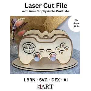 May include: A laser-cut wooden controller design. The controller has a cross-shaped directional pad, buttons, and two circular joysticks. The text "Laser Cut File" and "LBRN - SVG - DFX - AI" are visible. The design is for 3 mm wood.