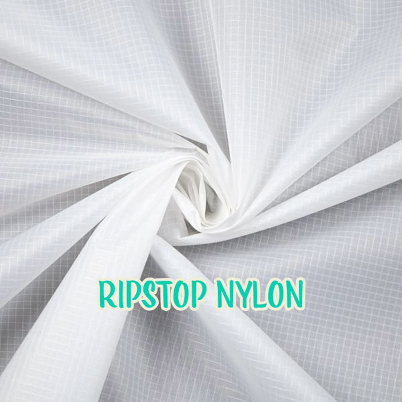 May include: White ripstop nylon fabric with a grid pattern. The fabric is folded and twisted, showing its texture. The text "RIPSTOP NYLON" is printed in green on the fabric.