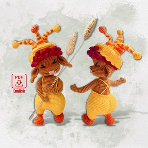 May include: Two crocheted amigurumi dolls with yellow and red hats and outfits. The dolls are holding a stalk of wheat.