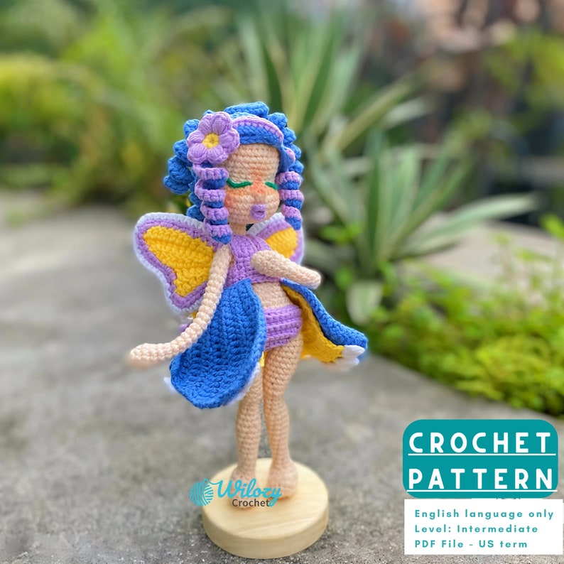 May include: Crochet pattern for a purple and blue fairy doll with yellow butterfly wings. The pattern is written in English and is for an intermediate crocheter. The pattern is available as a PDF file.