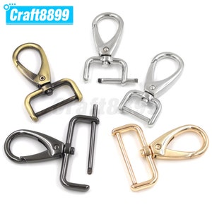 May include: Four swivel clasps in different finishes: antique brass, silver, black, and gold. Each clasp has a hook and a D-ring.