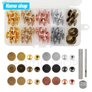 Könnte beinhalten: Eine transparente Kunststoff-Organizer-Box gefüllt mit verschiedenen Metallverschlüssen in Gold-, Silber-, Kupfer- und Bronzetönen. Die Box enthält Druckknöpfe und Magnetverschlüsse sowie Werkzeuge. Der Text "Hamo shop" ist sichtbar.