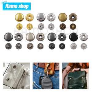 Puede incluir: Surtido de botones a presión de metal en varios colores y acabados, incluyendo oro, plata, negro y bronce. Los botones están dispuestos en filas sobre un fondo blanco.  Hamo shop.