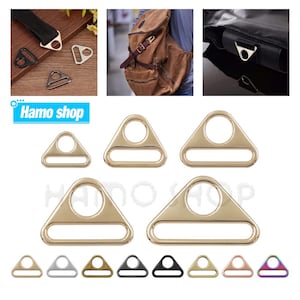 May include: Assortment of triangle-shaped metal D-rings in various sizes and colours, including gold, silver, black, bronze, rose gold, and iridescent. The D-rings are ideal for crafting, sewing, and DIY projects.