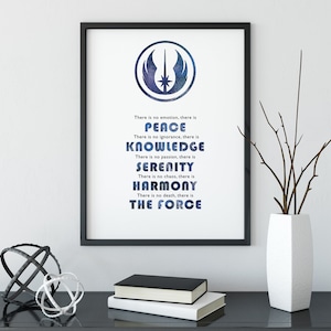 May include: A framed print with a blue and white galaxy-like design of the Star Wars Rebel Alliance symbol. The text below the symbol reads: "There is no emotion, there is PEACE. There is no ignorance, there is KNOWLEDGE. There is no passion, there is SERENITY. There is no chaos, there is HARMONY. There is no death, there is THE FORCE."
