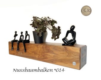 The wall shelf made of walnut wood beams combines rustic strength with refined elegance and makes a striking statement in any room.