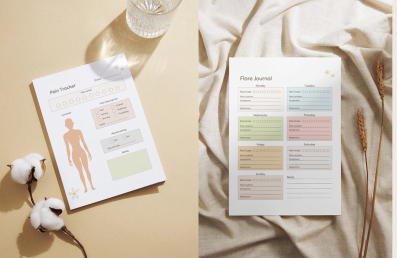 May include: Two white paper journals with floral accents. One is a pain tracker with a body diagram and pain level indicators. The other is a flare journal with daily sections for pain scale, location, symptoms, and medication.