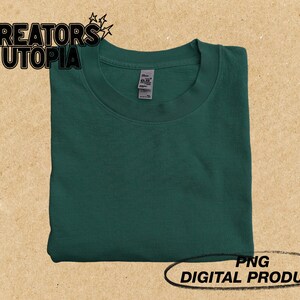May include: A folded green t-shirt with a white tag. The text "CREATORS UTOPIA" is visible in the top left corner of the image. The text "PNG DIGITAL PRODUCT" is visible in the bottom right corner of the image.