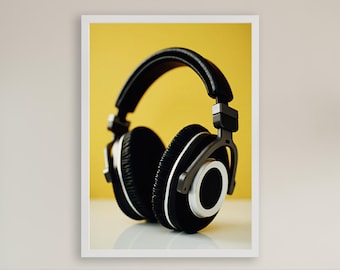 May include: Black over-ear headphones with silver accents against a yellow background.