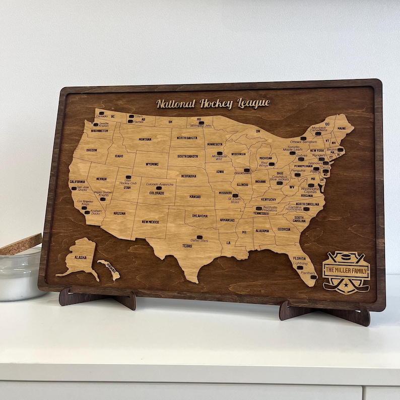 May include: A wooden map of the United States with the locations of National Hockey League teams marked. The map is on a stand and has a personalized plaque that says "The Miller Family".