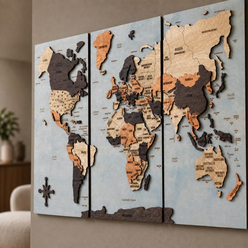 May include: A three-panel wooden world map wall art piece featuring raised, laser-cut continents in varying shades of brown, black, and natural wood tones. The map is set against a light blue background with engraved country names and borders.