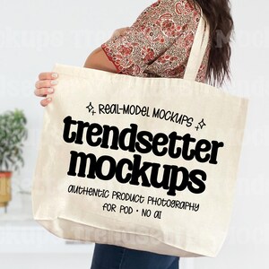 May include: A cream-coloured tote bag featuring the text "trendsetter mockups" in a bold, black font. The bag is held by a person wearing a patterned top. The text "Real-Model Mockups" and "authentic product photography for POD - NO AI" are also visible.