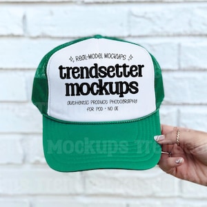 May include: A green and white trucker hat with the text "trendsetter mockups" in black. The hat has a green brim and mesh back, with the text "authentic product photography for POD - NO AI".