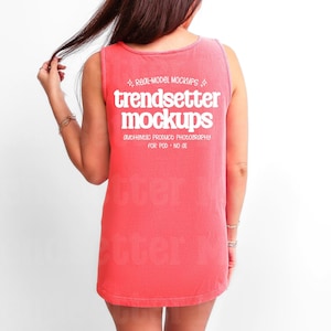 May include: A coral tank top with the white text "trendsetter mockups" on the back. The sleeveless top has a loose fit. The text "REAL-MODEL MOCKUPS" and "AUTHENTIC PRODUCT PHOTOGRAPHY FOR POD - NO 01" are also visible.