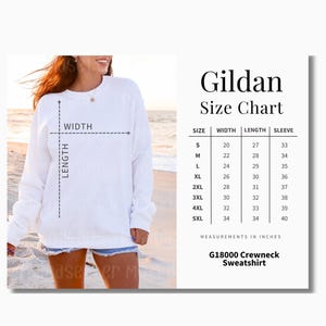 Puede incluir: Una sudadera Gildan blanca con cuello redondo y una tabla de tallas. La tabla muestra las medidas en pulgadas para las tallas S a 5XL, incluyendo ancho, largo y largo de manga. La sudadera es G18000.