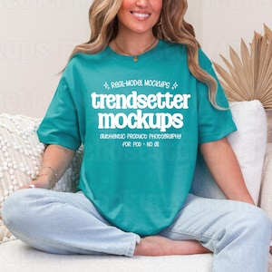 May include: A teal short-sleeve t-shirt featuring white text that reads "REAL-MODEL MOCKUPS", "trendsetter mockups", and "AUTHENTIC PRODUCT PHOTOGRAPHY FOR POD • NO 01" with small star accents above and below the main text.