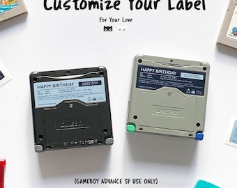 May include: Two Game Boy Advance SP game cartridges with custom labels. The labels are black and gray with the text "HAPPY BIRTHDAY" and the date "20231023". The text "GAMEBOY ADVANCE SP USE ONLY" and "2 sets of labels" is printed below the cartridges.