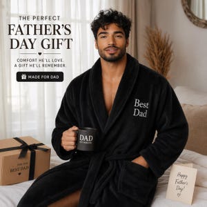 May include: A black plush robe with "Best Dad" embroidered on the chest. A matching mug with "DAD EST. FOREVER" is held in the hand. A gift box and a card that says "Happy Father's Day!" are also present. The text "THE PERFECT FATHER'S DAY GIFT" is at the top.