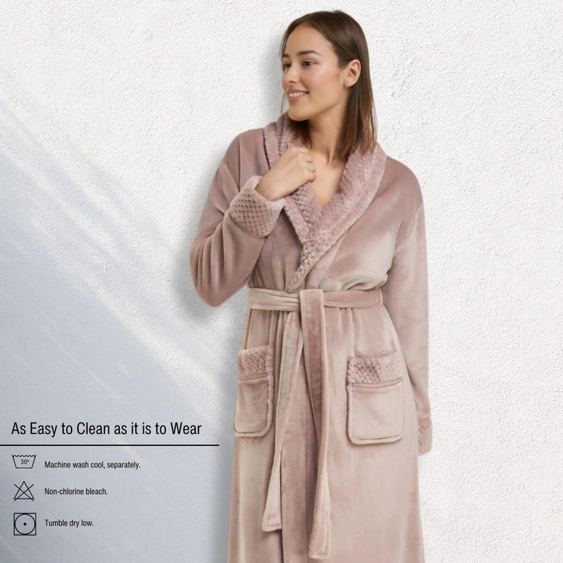 May include: A dusty rose-colored robe with a shawl collar and a matching belt. The robe has two front pockets and textured cuffs. The text "As Easy to Clean as it is to Wear" is visible, along with washing instructions.