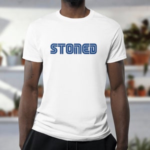 May include: White t-shirt with a blue "STONED" graphic in a retro video game font.