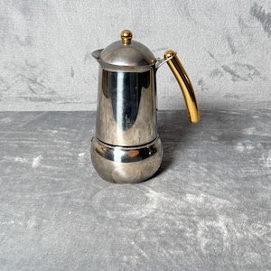 May include: A set of three ceramic vases in varying heights and shapes. The vases are glazed in a matte white finish, offering a minimalist aesthetic. The tallest vase is approximately 10 inches high.