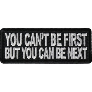 May include: Black embroidered patch with white text that reads "You can't be first but you can be next."